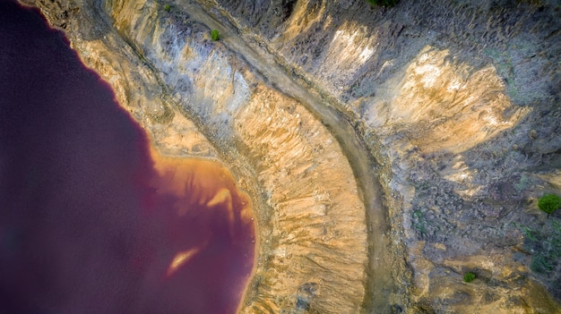 Red lake in mitsero, cyprus aerial view detail. its unnatural\
red and yellow colors are the result of the pyrite ore extraction\
in kokkinopezoula open pit mine.