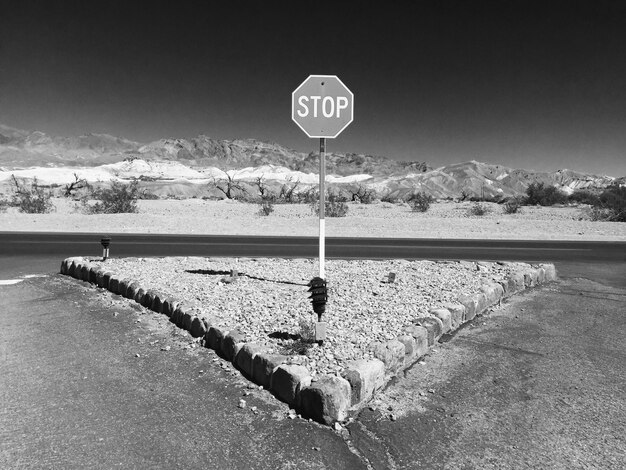 Premium Photo | Stop sign at road against clear sky