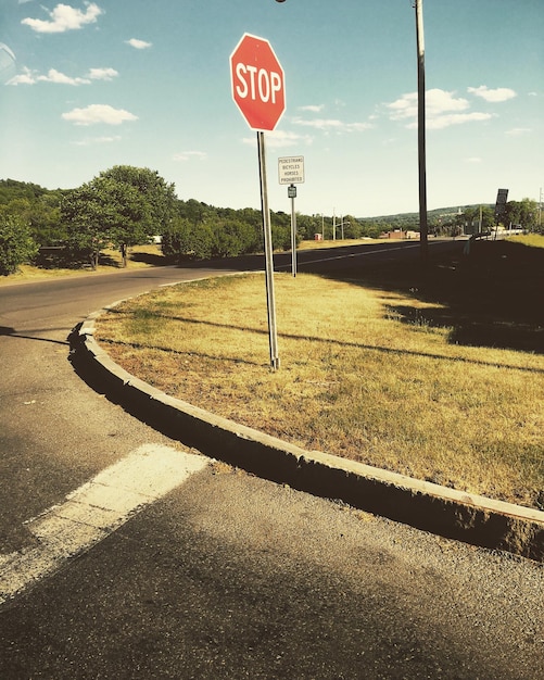 Premium Photo | Stop sign on road against sky