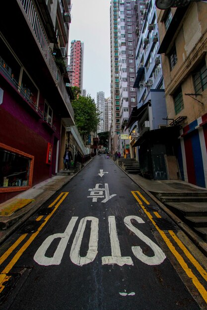 Premium Photo | Stop sign on road along buildings