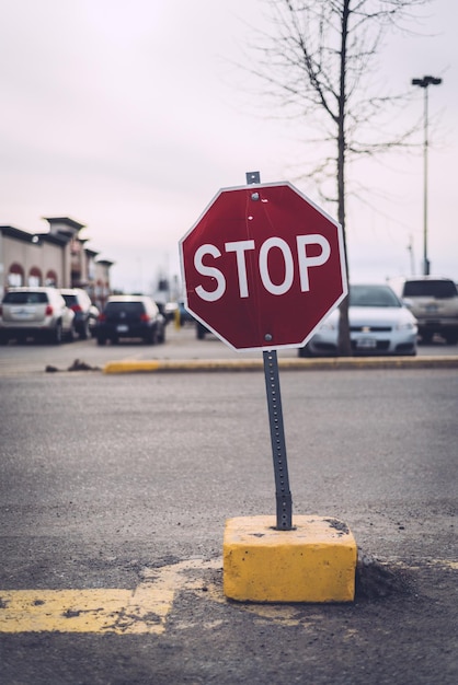 Premium Photo | Stop sign on road with cars in background