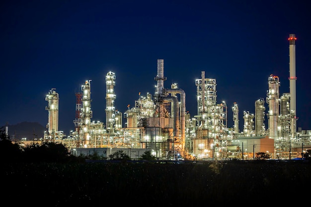 Premium Photo | Twilight scene of tank oil refinery plant and tower ...