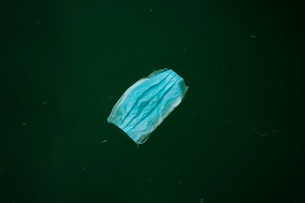 Waste mask is dumped in water water pollution