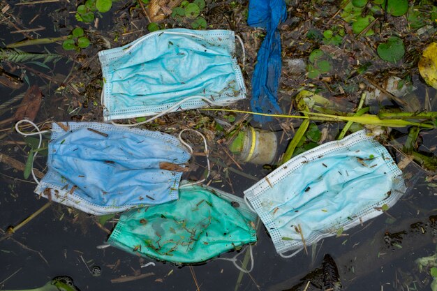 Waste mask is dumped in water water pollution