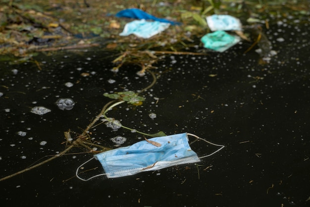 Waste mask is dumped in water water pollution