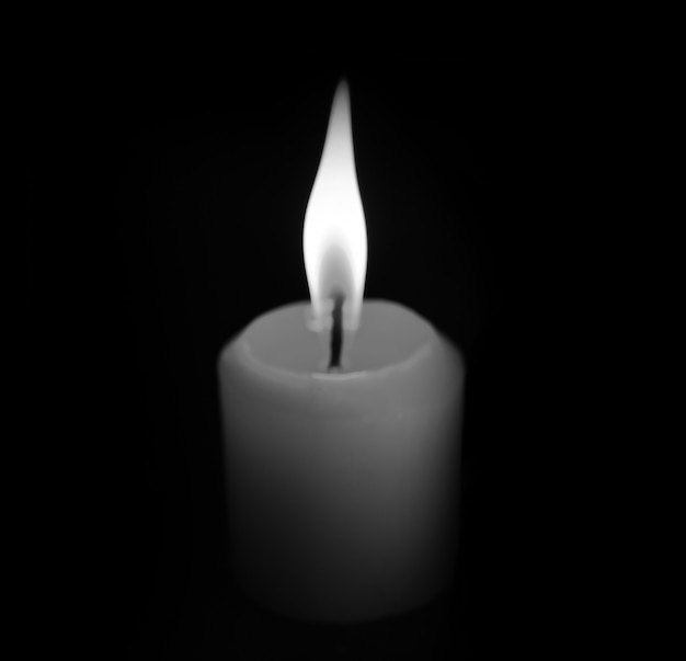 Premium Photo | White candle on black background