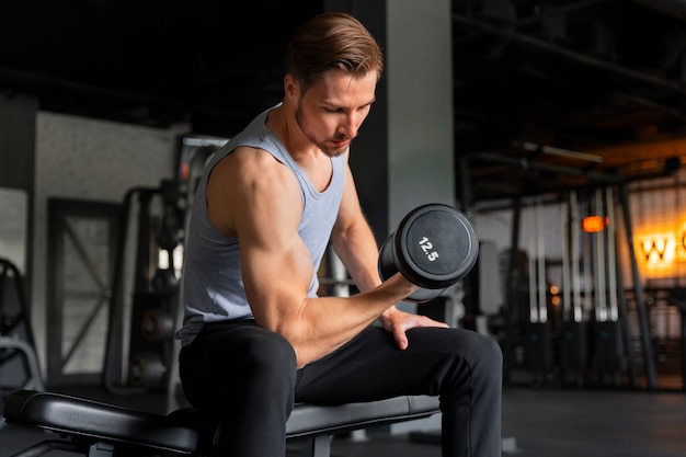 Premium Photo | Young handsome man exercising at the gym for bodybuilding