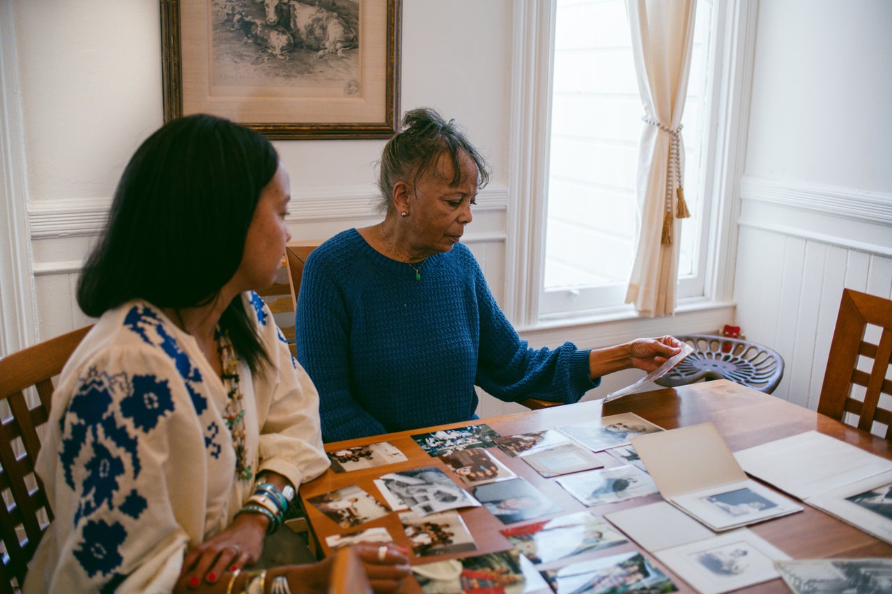 Kay Washington, left, looks through family photos and mementos with her mother Sondra Price.