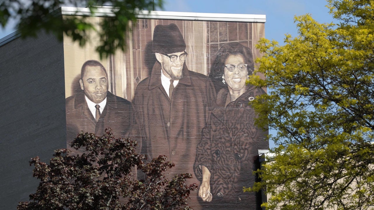 Rev. Franklin Florence and Constance Mitchell flank Malcolm X in a mural painted on the side of East High School in Rochester.