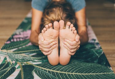 Woman Doing Yoga On A Yoga Mat, as a natural remedy for plantar fasciitis