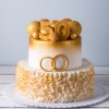 Two tiered cake with wedding rings and a 50 on top.