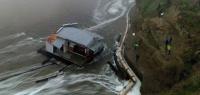 This aerieal view shows people looking at the collapsed pier at the Santa Cruz Wharf in Santa Cruz, California, on December 23, 2024. A pier collapsed into the ocean and floated away off the US state of California on Monday, weather authorities said, as the region was pounded by a powerful storm. Lifeguards rescued two people after the structure in Santa Cruz broke free, firefighters said, while a third person managed to get themselves out of trouble. (Photo by Daniel Dreifuss / AFP)