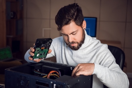 Technician repairing computer in service center