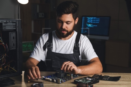 Technician repairing computer in service center