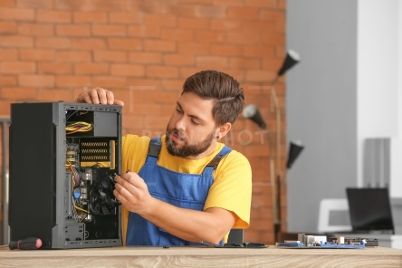 Technician repairing computer in service center