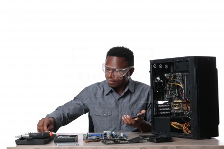 African-American technician repairing computer on white background