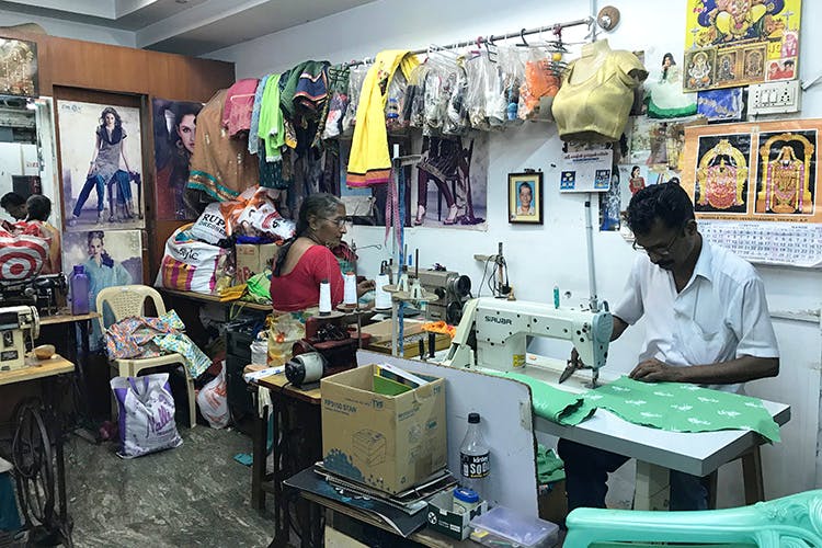 Sewing machine,Tailor,Selling,Dressmaker,Art,Textile,Shopkeeper,Building,Home appliance