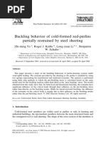 Buckling Behavior of Cold-Formed Zed-Purlins Partially Restrained by Steel Sheeting