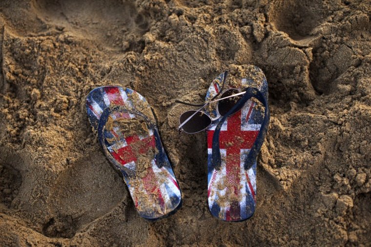 FILE: The flip flop sandals of a holidaymaker decorated with the British union flag, also known as the Union Jack, sit on the sandy beach in Benidorm, Spain, on Monday, July 11, 2016. European Union and Jack flags as Brexit trade talks that were on the verge of a breakthrough descended into a fight between the U.K. and France on Thursday as the British government said prospects of an imminent deal had receded. Photographer: Matthew Lloyd/Bloomberg via Getty Images