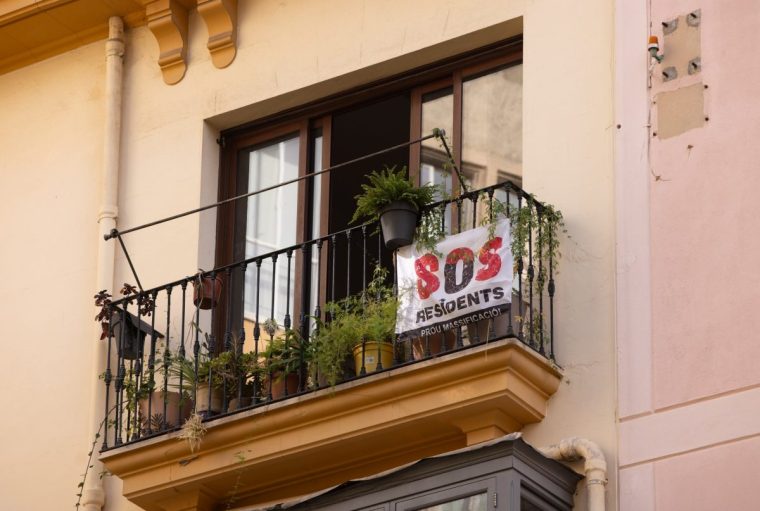 A banner reading "SOS Residents. Prou Massificaci" (Enough Massification) on an apartment balcony in Palma de Mallorca, Spain, on Friday, July 26, 2024. Southern European cities including Lisbon and Madrid saw strong growth in residential-property values in the first half of the year, as an ongoing supply crunch buoyed the high-end housing market.??Photographer: Andrey Rudakov/Bloomberg via Getty Images