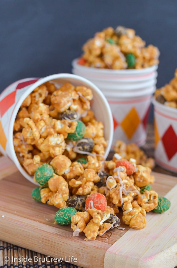 Caramel Pumpkin Spice Popcorn - pumpkin spice candies and marshmallows add a fun flair to this caramel covered popcorn mix. Make this easy recipe for fall parties!