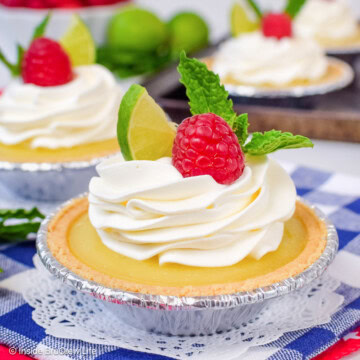 A mini key lime tart on a blue and white towel.