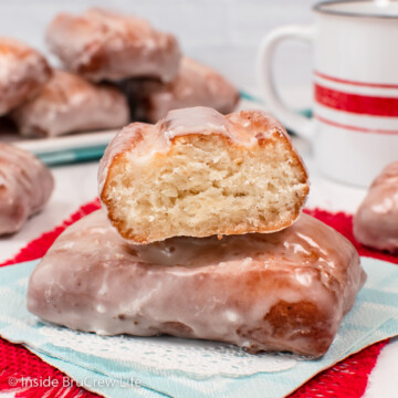 Fried donuts stacked on a napkin.