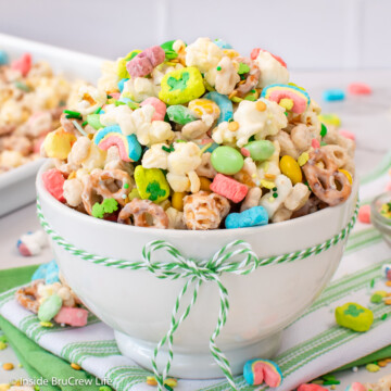 A white bowl filled with a st. patrick's day snack mix.