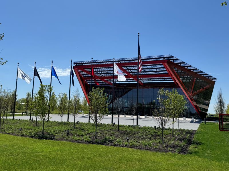 Front view of the Pritzker Military Archives Center building with flags in the fore front