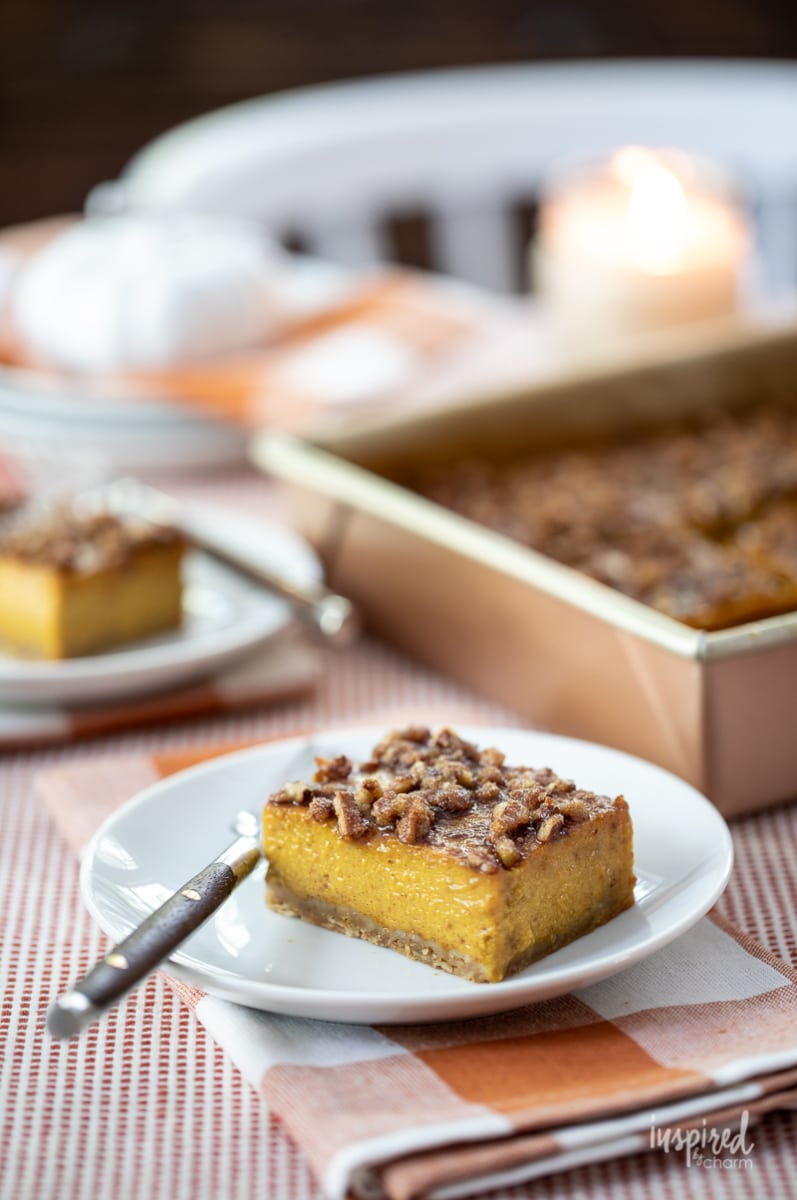 pumpkin pie bar served on a small white plate with a fork. 