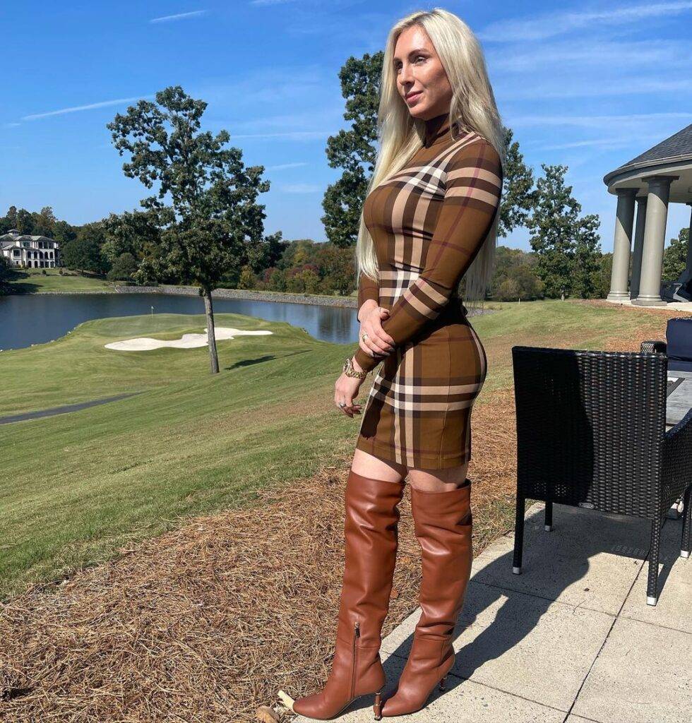 Charlotte Flair is looking hot and wearing long brown shoes and posing for the picture