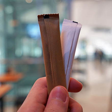 a person holding 2 stick packs