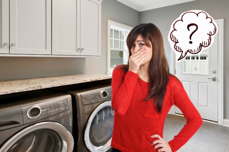 woman covers nose due to smelly laundry room