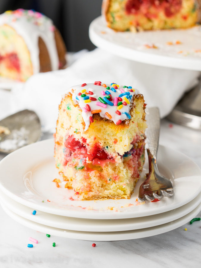 This Cherry Surprise Cake is a moist funfetti cake that's filled with cherry pie filling! So fun and so delicious, my whole family loved it!