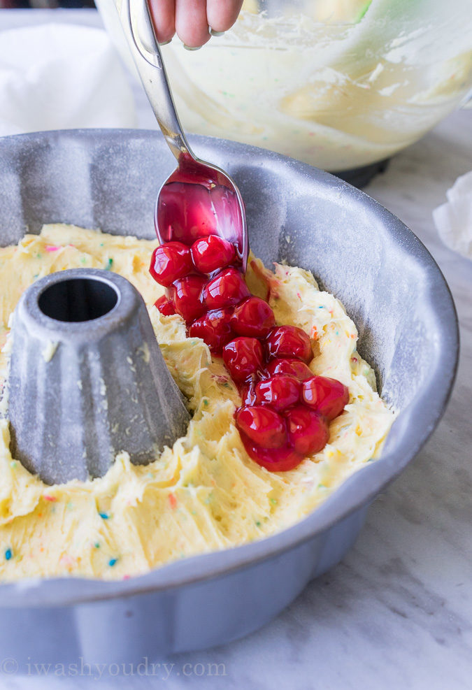 This Cherry Surprise Cake is a moist funfetti cake that's filled with cherry pie filling! So fun and so delicious, my whole family loved it!