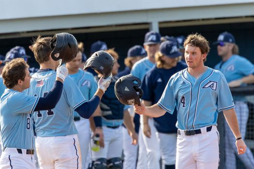 Baseball players celebrating with their helmets