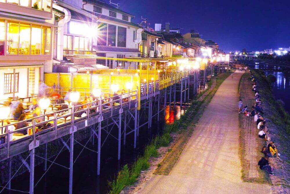 The building on the right is called "Yuka", the local restaurant seats in a location where the Kamogawa river can be seen outdoors, Kyoto, Japan = AdobeStock