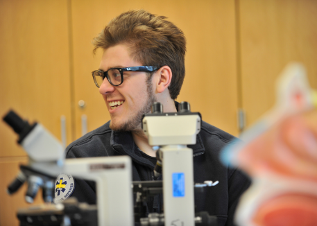 pre-health student in front of medical model