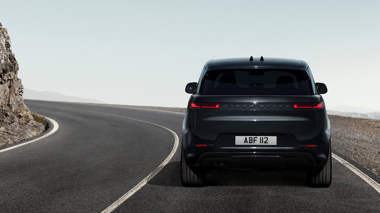 Back view of Range Rover Sport parked on road