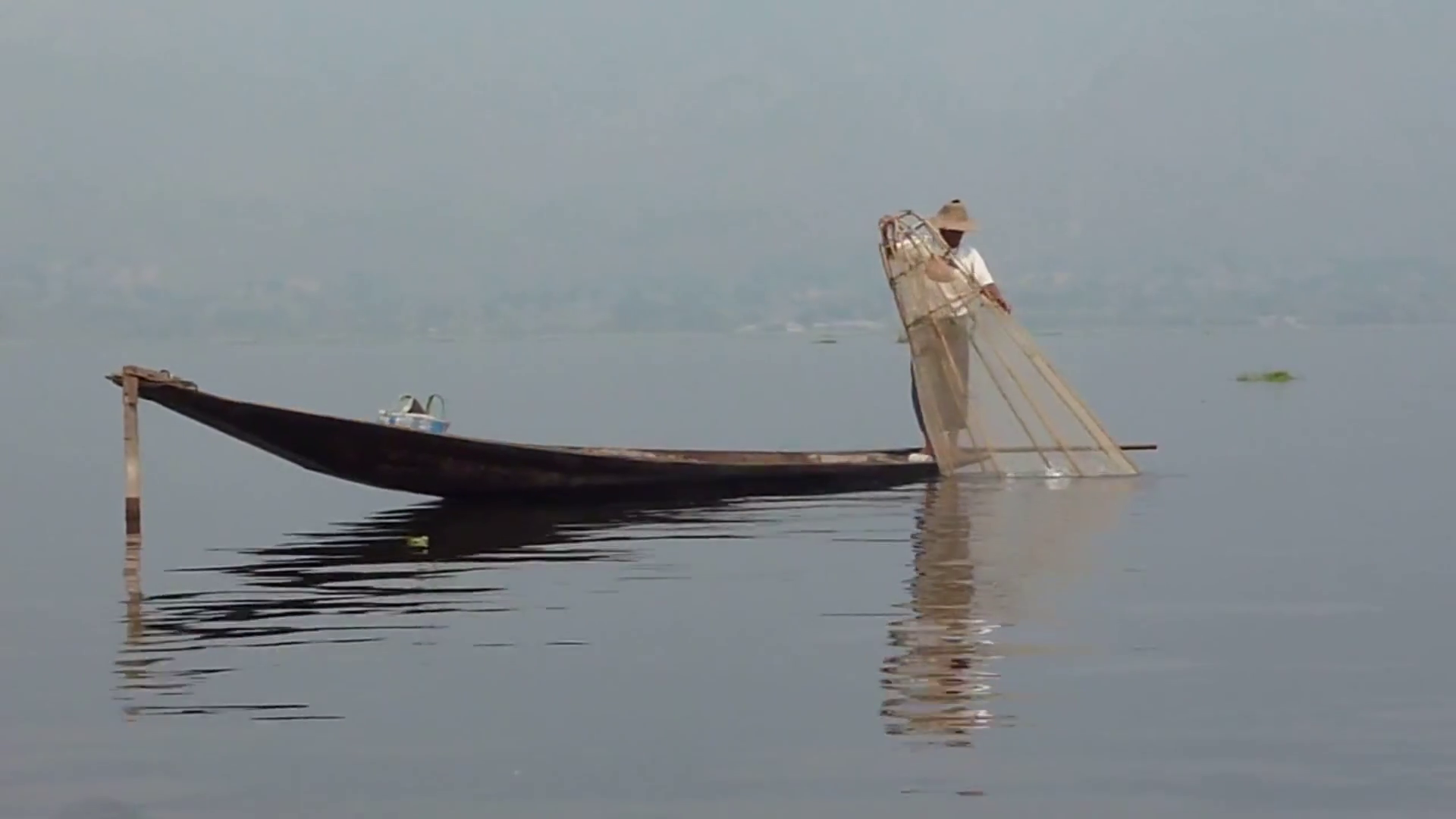 Traditional fisherman rowing on the old boat trough the pond Stock ...