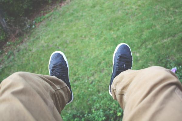 Person Wearing Brown Pants and Black and White Shoes