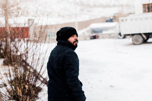 Photo of a Man Wearing Coat During Snow