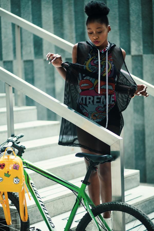 Woman Wearing Black and Red Crew-neck Sleeveless Dress Standing on Gray Metal Stair