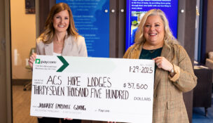 Amy Cook, senior director of operations at Paycom, and a representative from the American Cancer Society hold a $37,500 donation check for Hope Lodge communities. (Photo/Paycom)