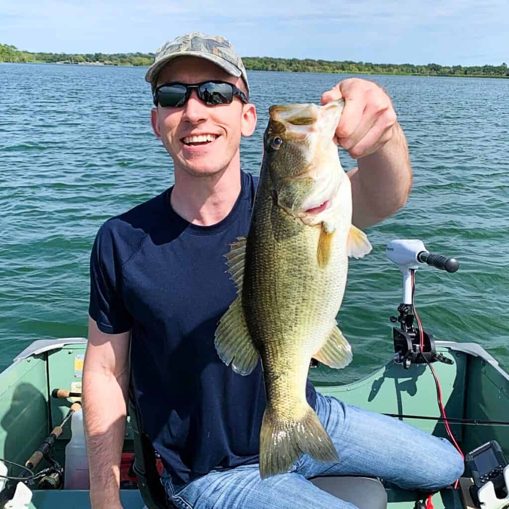 andrew juran holding largemouth bass held vertically