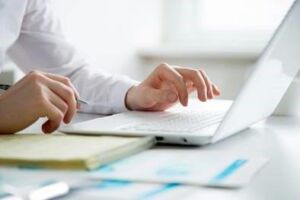 individual sitting in front of a laptop