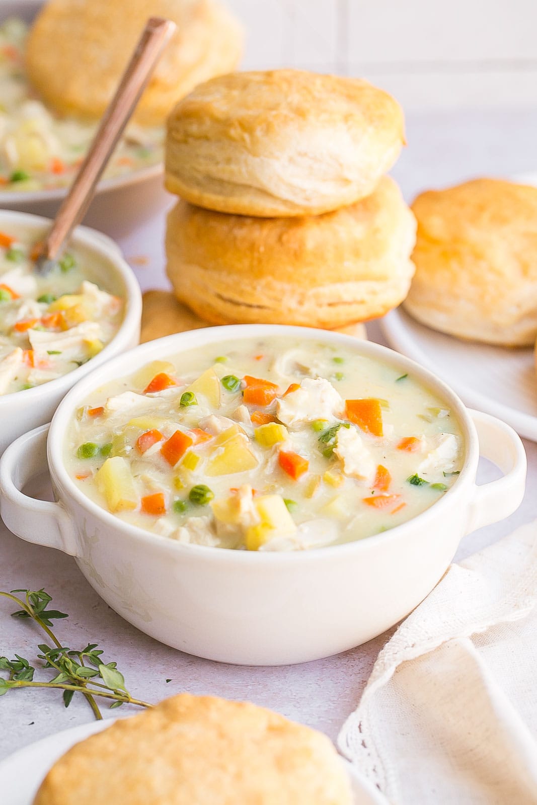 Bowl of soup with stack of biscuits.