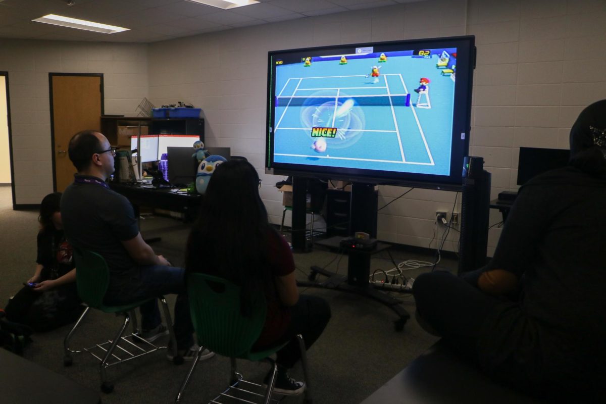 A behind view of Juan Duran's and senior Noemi Campuzano's gameplay.