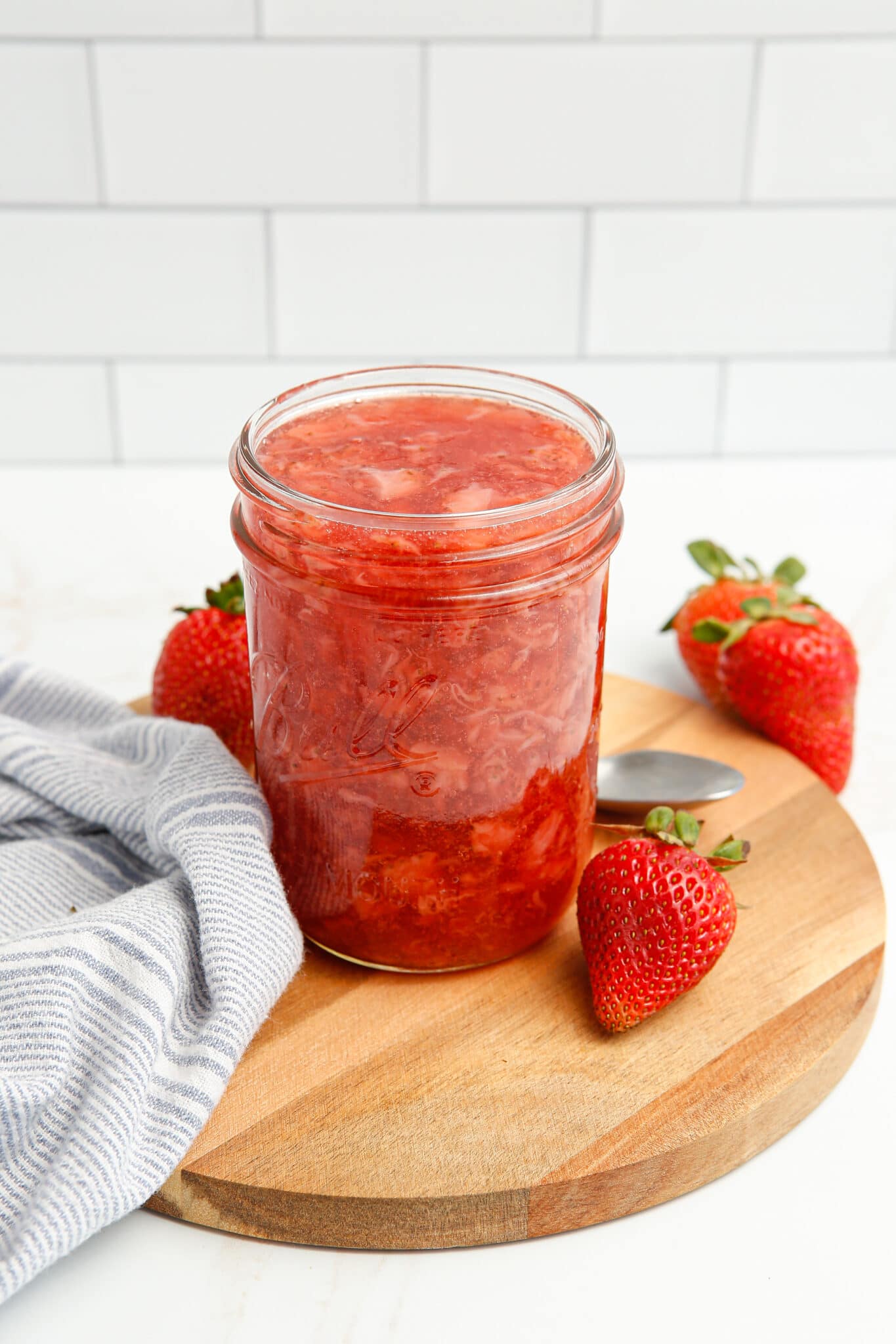 Strawberry Pie Filling on a wooden board.