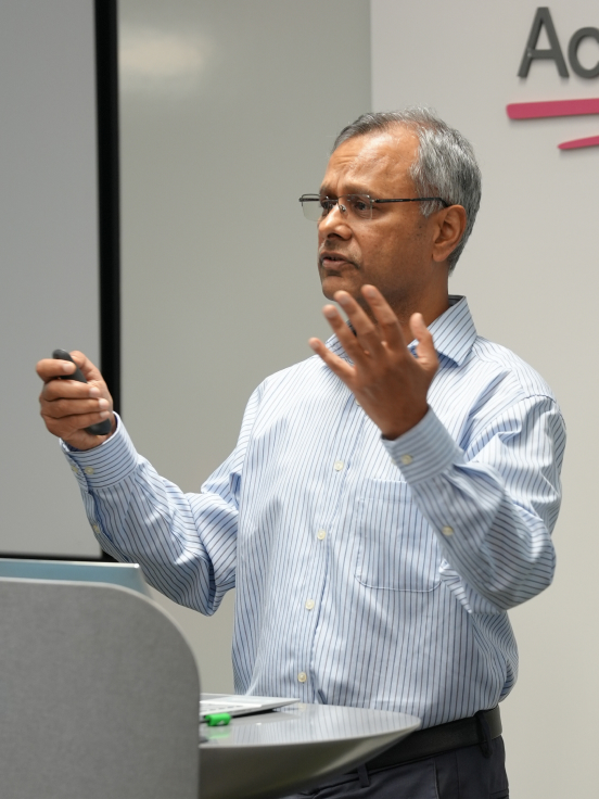 A man is speaking while looking in front.